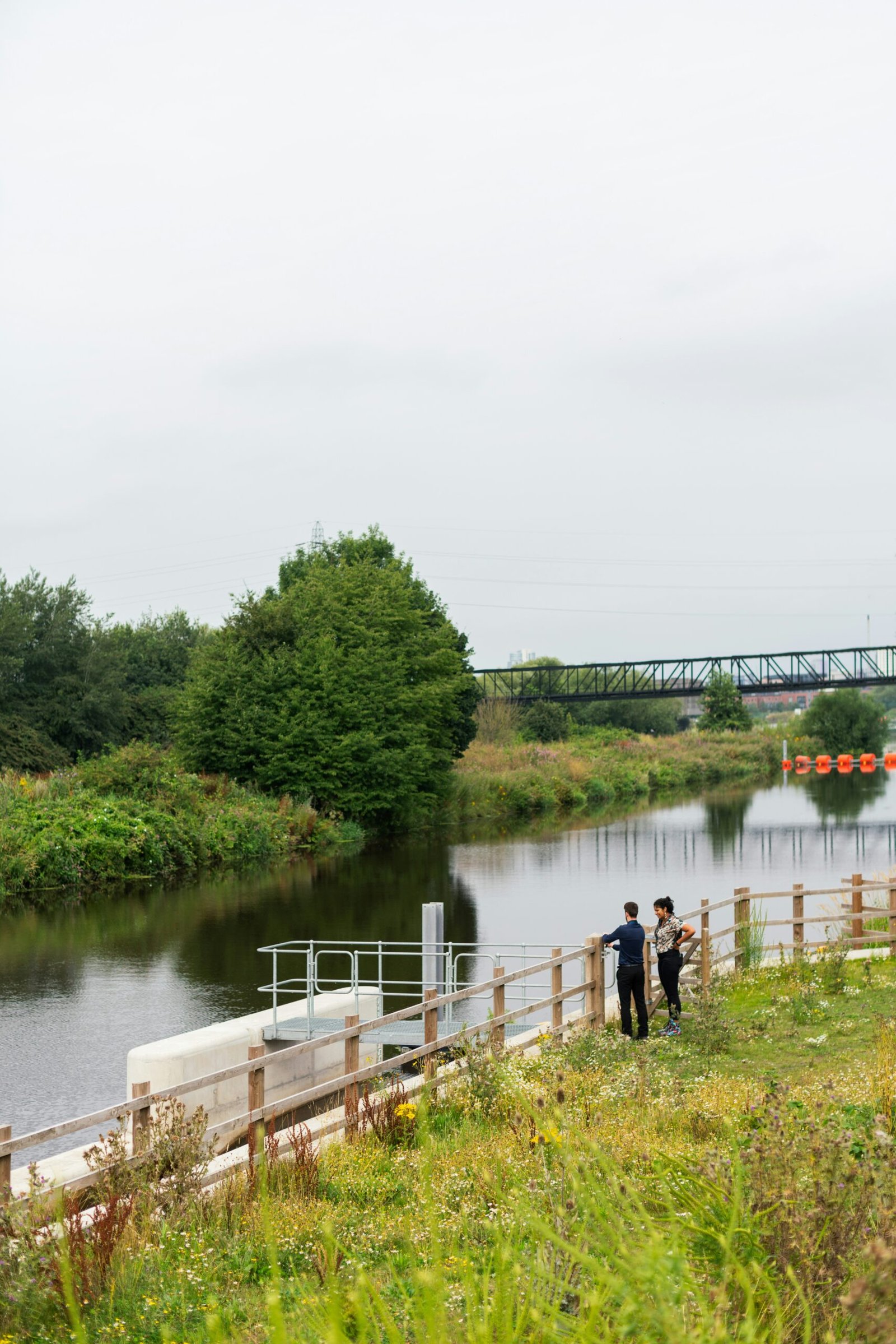 people walking on wooden dock over river during daytime